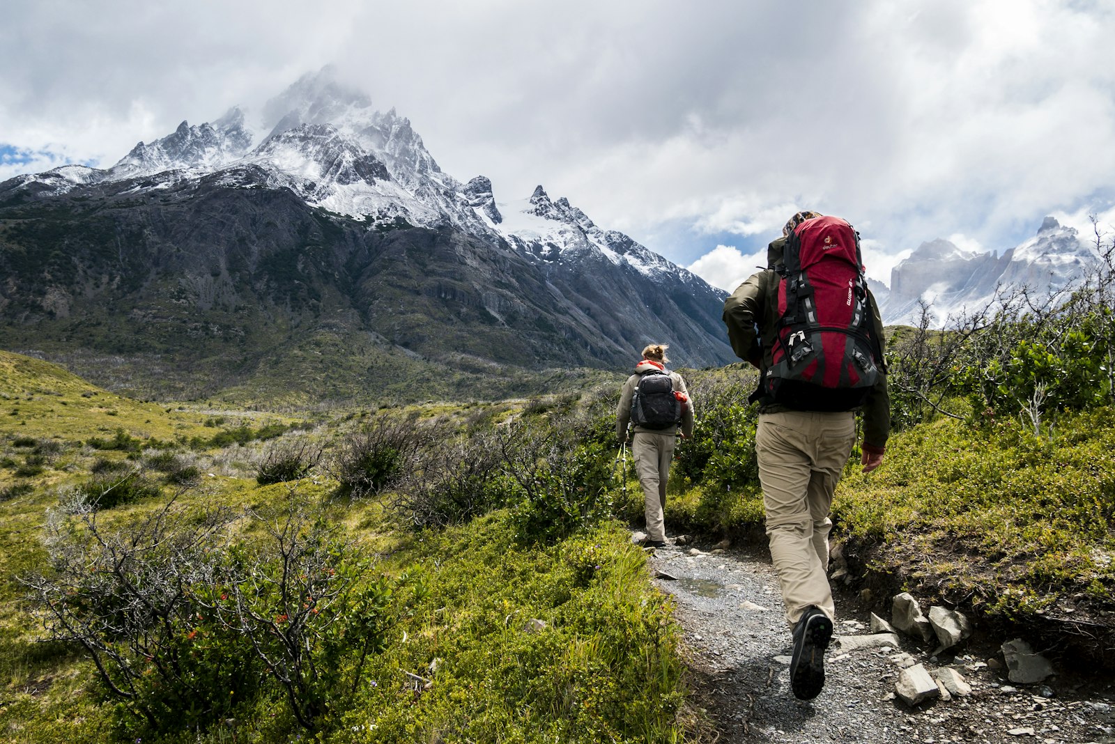Hikers with backpacks on a mountain trail